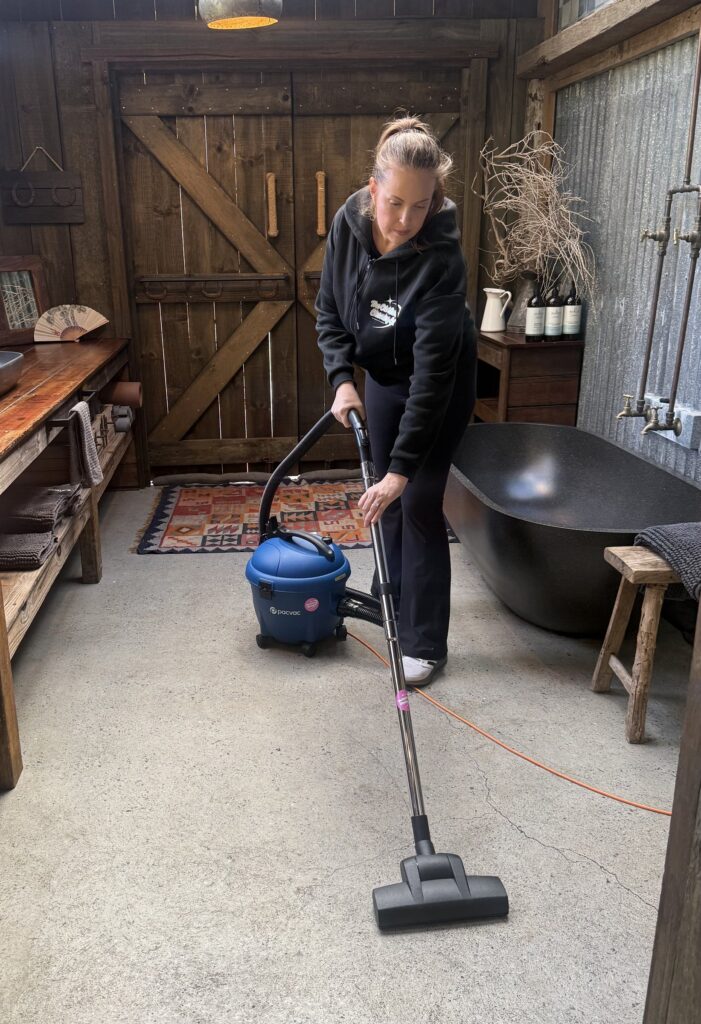 Cleaner vacuuming hinterland home in Currumbin Valley, Gold Coast. The Old School Cleaning Co.