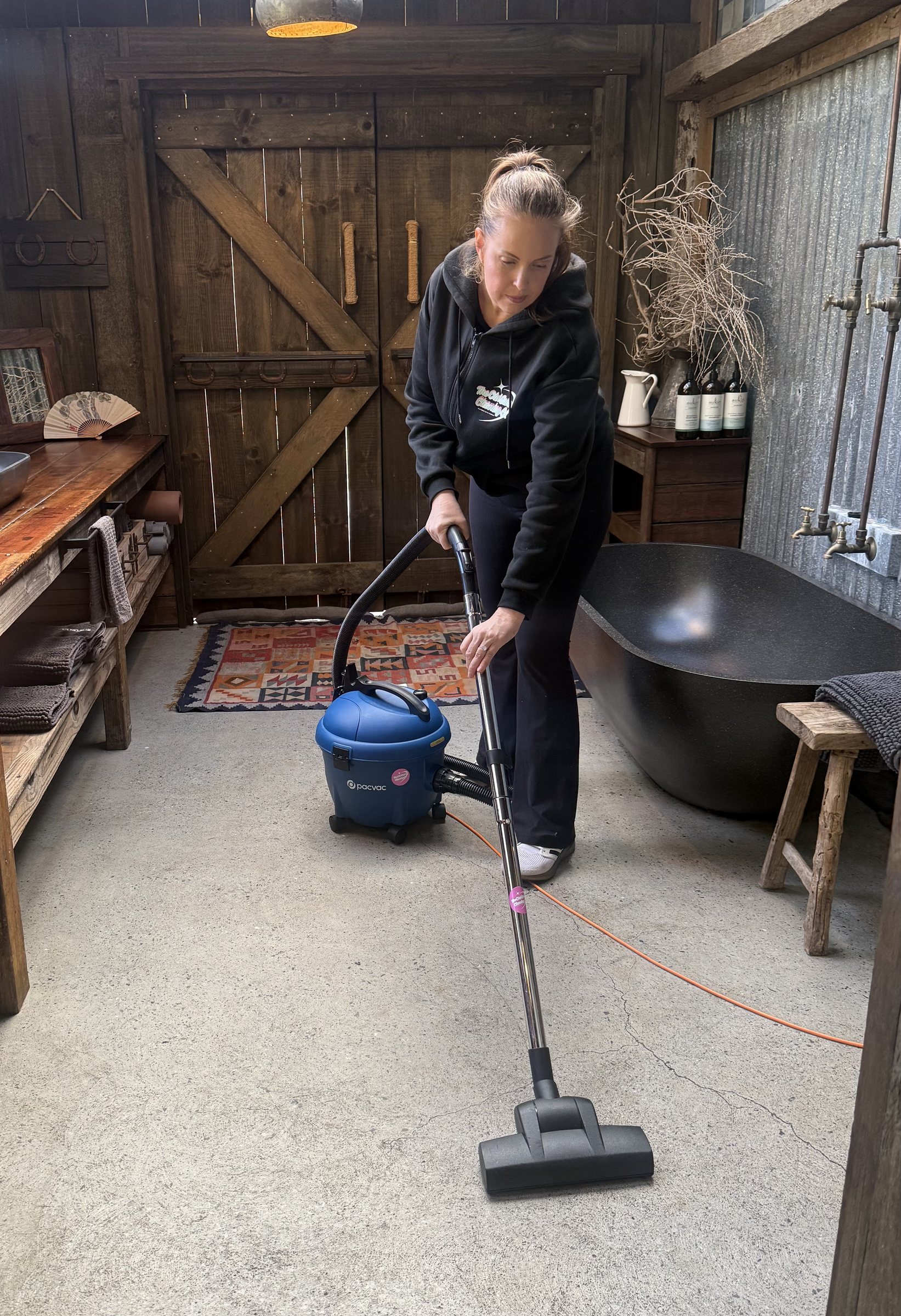 Cleaner vacuuming hinterland home in Currumbin Valley, Gold Coast. The Old School Cleaning Co.