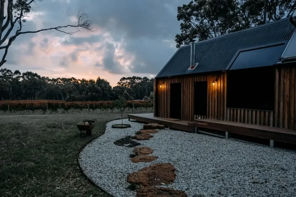 Timber cabin on hinterland acreage with lawn and fire pit at dusk, Gold Coast, The Old School Cleaning Co.