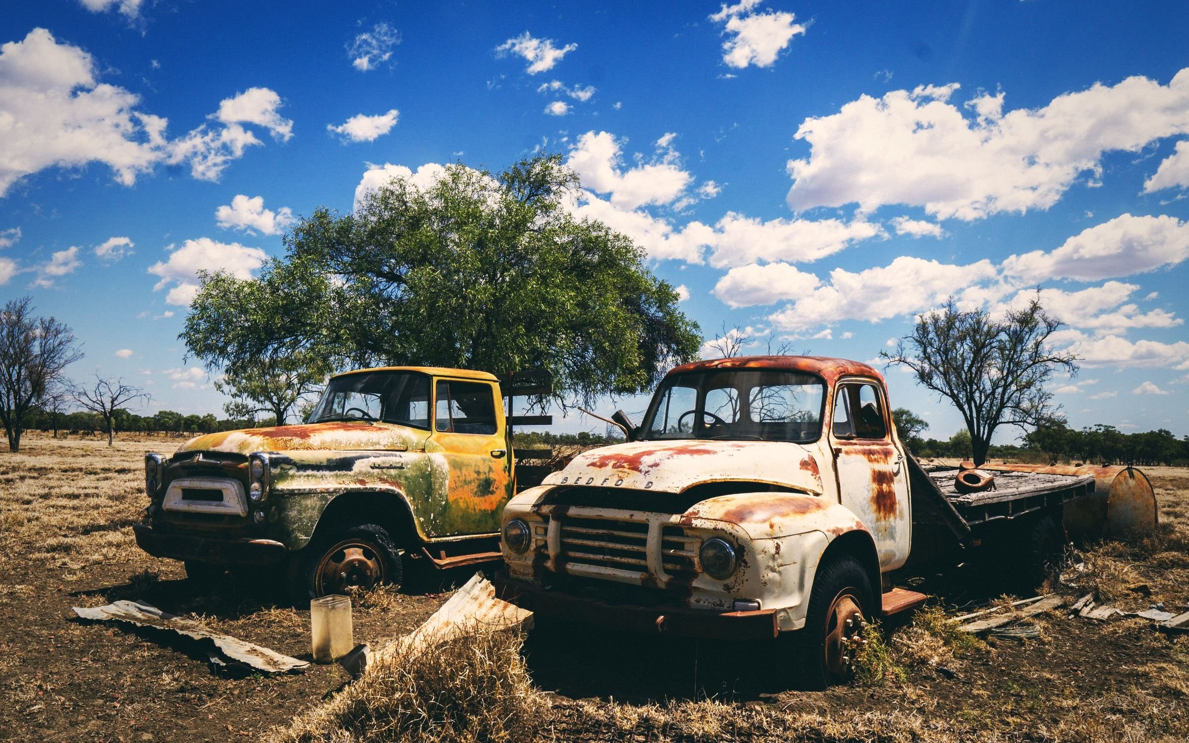 Two vintage trucks in the Australian countryside